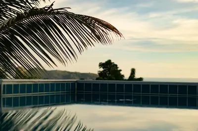 a view of a swimming pool with the ocean in the background at Cozy 5BR Villa Stunning SeaViews in Kamala Beach