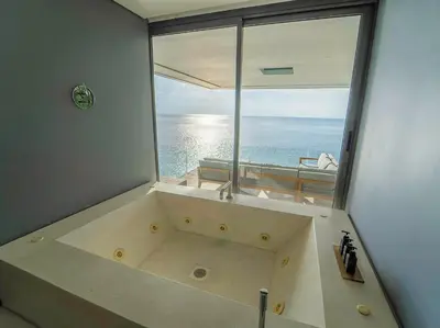 a large bath tub with a view of the ocean at Villa Amanzi Kamala by Elite Havens in Kamala Beach