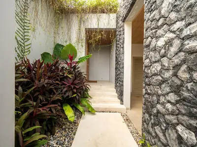 a hallway of a house with plants at Exclusive Villa Botanica in Bang Tao Beach