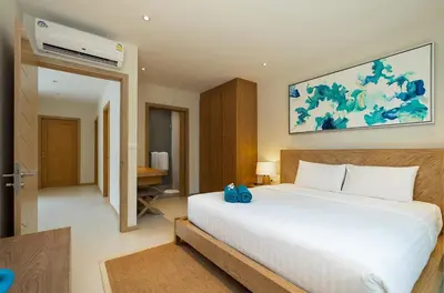 a bedroom with a large white bed in a room at 3-Bedroom Pool Villa in Trichada Sky at Bangtao in Bang Tao Beach