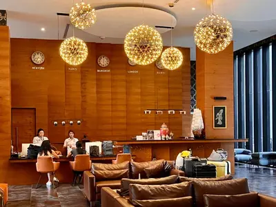 two people sitting at a counter in a lobby at Kamala Beach D723 Exclusive 2 bedroom Suite in Kamala Beach