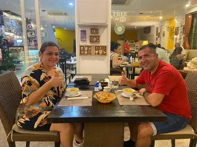 a man and a woman sitting at a table at Istanbul Boutique Hotel in Patong Beach