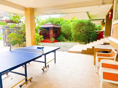 a ping pong table in the middle of a patio at Orchid Pool Villa - SHA Extra Plus - indoor Warm pool in Phuket Town
