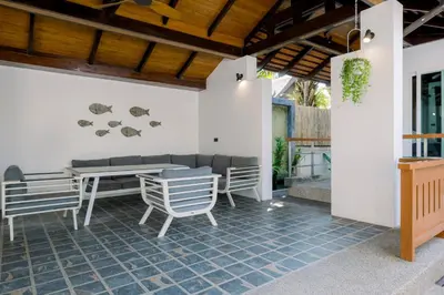 an outdoor patio with a table and chairs at Luxurious Residence Rawai in Phuket Town