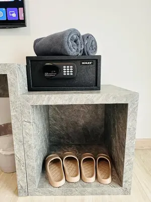 a fireplace with two pairs of shoes and a towel at Kata Place Villa in Kata Beach