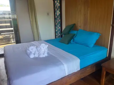 a bed with two towels on top of it at Banpoo in Ko Yao Noi