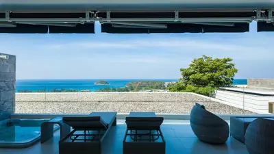 a view of the ocean from a room with chairs at The Kata View Phuket apartment in Kata Beach