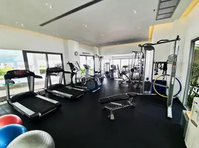a gym with several treadmills and cardio machines at The Kata View Phuket apartment in Kata Beach