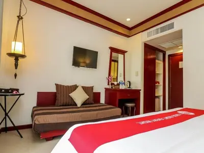 a hotel room with a bed and a couch at THE TOP PATONG RESORT. in Patong Beach
