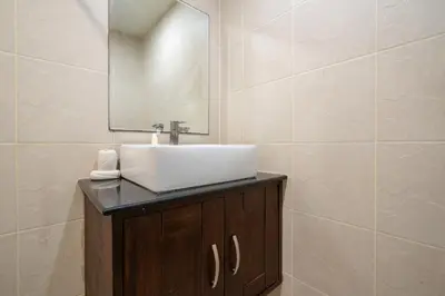 a bathroom with a sink and a mirror at Beachside Apt Short Walk to Nai Harn Beach 2-3 BR in Nai Harn Beach