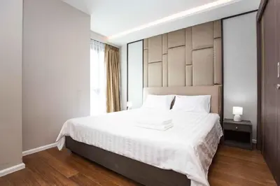 a bedroom with a large white bed and a window at The Panora apartments by NLA in Surin Beach