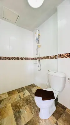 a bathroom with a toilet and a shower at Jasmin Guest House in Patong Beach