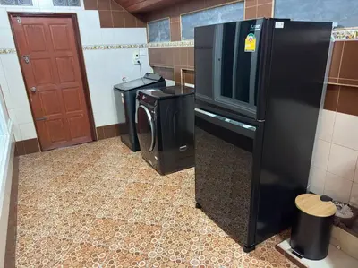 a kitchen with a refrigerator and a washer and dryer at Kathu Home with Mountain View in Kathu