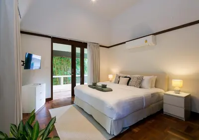 a bedroom with a large white bed and a television at Katamanda 1Bedrooms Apartment near Kata Beach in Kata Beach