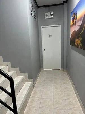 a hallway with stairs and a white door at S a f e Residence Patong in Patong Beach