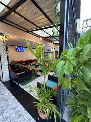 a lobby of a building with plants in it at Blueskyhouse Patong in Patong Beach
