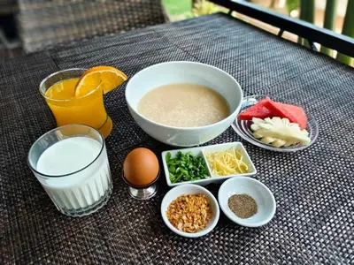 a table with a bowl of food and other ingredients at Touch Sea Boutique Hotel&Bistro in Karon Beach