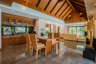 a kitchen and living room with a table and chairs at Solas Pool Villa Grand Villa With Private Pool in Rawai Beach