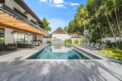 an infinity pool in the backyard of a villa at Eden Villa A Tropical Paradise Pool Villa in Rawai Beach