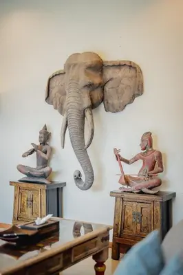 an elephant on a wall with two statues on tables at Ivory Pool Villa Dreamy Villa With Sparkling Pool in Rawai Beach