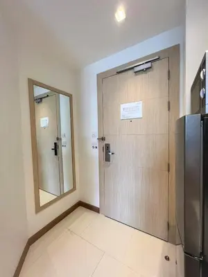 a bathroom with a sliding door and a mirror at Maroon Studio at the beachfront in Rawai Beach