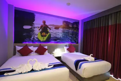 a hotel room with two beds and a painting on the wall at KRABI Residence in Ban Khlong Haeng