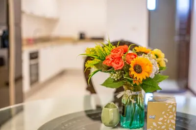 a vase filled with flowers sitting on a table at Phuket Boutique Pool Villa-80 in Rawai Beach