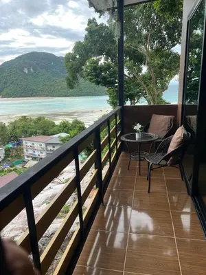 a balcony with a view of the beach at The view Hostel in Phi Phi Don