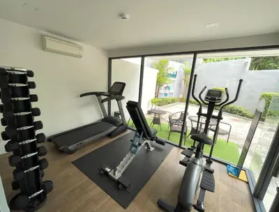 a gym with cardio equipment in a house at Cozy studio Splendid Condo by Lofty in Kata Beach