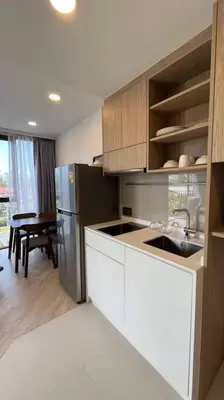 a kitchen with a sink and a refrigerator at Laguna Sky Park Corner 1 Bedroom in Bang Tao Beach