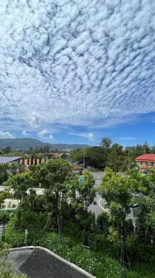 a cloudy sky above a street with trees and a road at Laguna Sky Park Corner 1 Bedroom in Bang Tao Beach