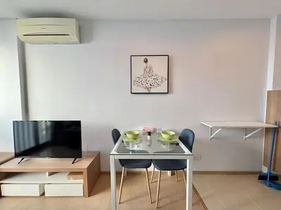 a living room with a table and a television at Zcape X2 Condos in Bangtao in Bang Tao Beach