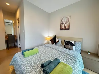 a bedroom with a bed with two pillows on it at Zcape X2 Condos in Bangtao in Bang Tao Beach