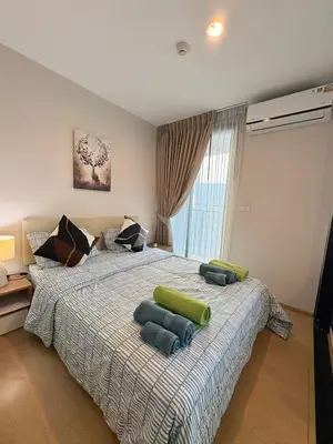 a bedroom with a bed with two pillows on it at Zcape X2 Condos in Bangtao in Bang Tao Beach