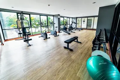 a gym with a row of treadmills and machines at Zcape X2 Condos in Bangtao in Bang Tao Beach