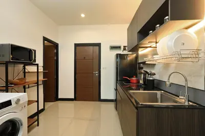 a small kitchen with a sink and a stove at 1 bdr Apartment Naiharn Beach Condo by CapitalPro in Phuket Town