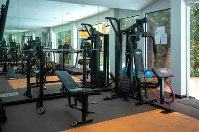 a gym with a lot of treadmills and machines at 1 bdr Apartment Naiharn Beach Condo by CapitalPro in Phuket Town