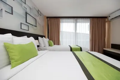 a hotel room with two beds and a window at iCheck inn Sky Beach Ao Nang Krabi in Ao Nang Beach