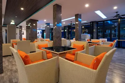 a restaurant with orange chairs and a table at iCheck inn Sky Beach Ao Nang Krabi in Ao Nang Beach