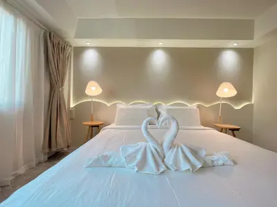 a bed with two swans made to look like hearts at Upsea patong in Patong Beach