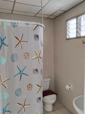 a bathroom with a shower curtain with starfish at Urban Patong Residence in Patong Beach