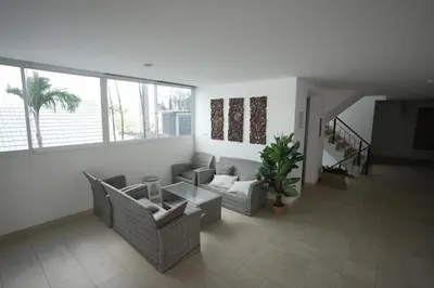 a living room with couches and a table at Calypso Condo Rawai Nai Harn beach in Rawai Beach
