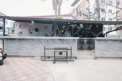 a bar with a table in front of a building at O'Shop Residence Patong Beach in Patong Beach