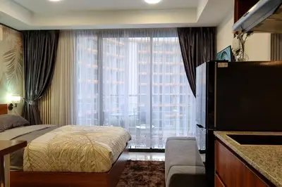 a bedroom with a bed and a large window at CB408 Apartament Beach condo 777 in Phuket Town