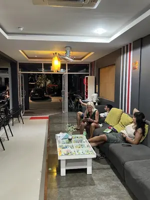 a group of people sitting on a couch in a living room at Hangover Aonang in Ao Nang Beach