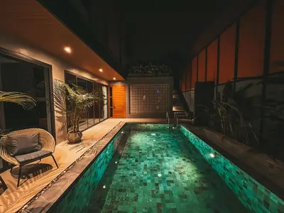 a swimming pool in the middle of a house at night at Le Villa Residence in Phuket Town