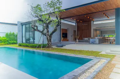 a swimming pool in front of a house at Botanica Foresta 4BR Luxury Villa with Pool by NLA in Bang Tao Beach