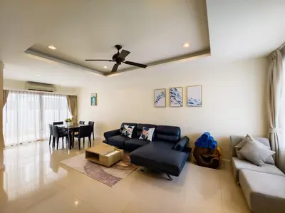 a living room with a couch and a table at Townhouse in Laguna Park in Phuket Town