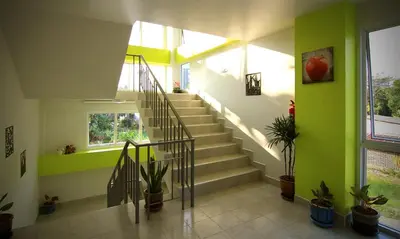 a staircase in a house with green walls at Shyne Place in Phuket Town