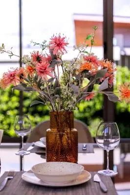 a vase filled with flowers sitting on a table at Villa Mimosa 3, Luxury 4Bedroom Private Pool-Rawai in Kata Beach